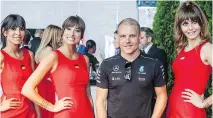  ?? OCTANE RACING ?? RED HOT: Mercedes AMG Petronas driver Valtteri Bottas is flanked by hostesses at the F1 GP benefit event kickoff, Le Grand Soir.