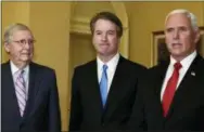  ?? THE ASSOCIATED PRESS ?? Vice President Mike Pence, right, speaks about Supreme Court nominee Brett Kavanaugh, center, as Senate Majority Leader Mitch McConnell of Kentucky, left, listens during a visit to Capitol Hill in Washington on Tuesday.