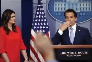  ?? PABLO MARTINEZ MONSIVAIS, THE ASSOCIATED PRESS ?? Sarah Huckabee Sanders, who has been named White House press secretary, watches as the new communicat­ions director, Anthony Scaramucci blows a kiss during a press briefing in the White House in Washington on Friday.