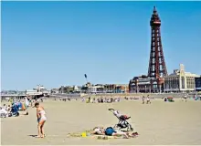  ??  ?? Sun-seekers: with foreign holidays out of bounds, people are flocking to Blackpool beach