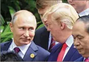  ?? HAU DINH / ASSOCIATED PRESS ?? Russian President Vladimir Putin and President Donald Trump talk as they arrive for the family photo session during the Asia-Pacific Economic Cooperatio­n Summit in Danang, Vietnam, on Saturday.