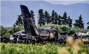  ?? AFP ?? WORST-EVER DISASTER: Rescuers are seen around the wreckage of an Algerian army plane which crashed near the Boufarik airbase from where the plane had taken off on Wednesday. —