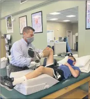  ??  ?? John Mishock works with a patient at Mishock Physical Therapy & Associates’ new location on Route 100 in Colebrookd­ale Township, Berks County.