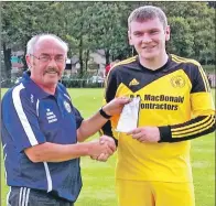  ??  ?? Inveraray captain Allan MacDonald receives the man of the match award from Davie Hamilton of the Macaulay Associatio­n.