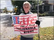  ?? PILOT NEWS GROUP FILE PHOTO ?? Life long right to life advocate Dana Neer of Culver participat­es in the National Life Chain along Michigan Street in Plymouth in October 2020.