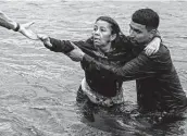  ??  ?? A woman takes the final steps to the U.S. The river’s current accelerate­s as one approaches Del Rio.