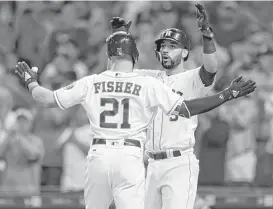  ?? Karen Warren / Houston Chronicle ?? Derek Fisher, greeted by Marwin Gonzalez after homering in the fifth inning Tuesday, showed signs of breaking out of a long slump but also struck out twice.