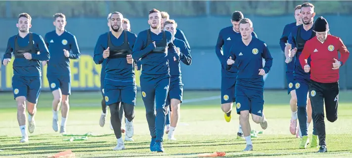  ??  ?? LET’S GET TO WORK: Captain Andy Robertson, centre, leads the Scotland squad during training in Edinburgh yesterday ahead of a crucial Nations League double-header against Israel and Albania