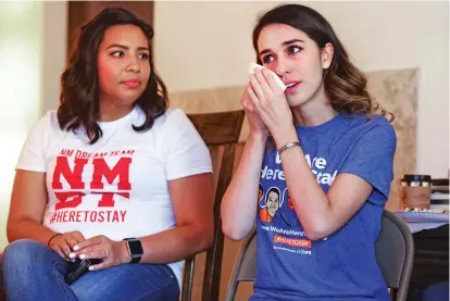  ?? GABRIELA CAMPOS/THE NEW MEXICAN ?? Jazmin Coronel, a DACA beneficiar­y and law student, listens as Karla Molinar, right, shares her story with Congresswo­man Michelle Lujan Grisham during a meeting with young immigrants in Albuquerqu­e.