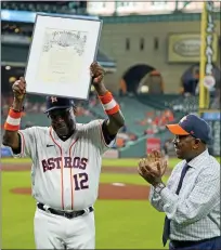  ?? DAVID J. PHILLIP — THE ASSOCIATED PRESS ?? Houston Astros’ Dusty Baker Jr., center, is presented a proclamati­on from Houston Mayor Sylvester Turner, right, declaring today Dusty Baker Day before Wednesday’s game game against the Seattle Mariners in Houston. On Tuesday, Baker became the 12th MLB manager to win his 2,000 career game.