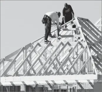  ?? Calgary Herald/files ?? Constructi­on workers put together the roof of a new home in Calgary last summer. Reader says students shouldn’t enter the trades if their hearts aren’t in it.