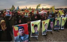  ?? GETTY IMAGES ?? Family members and comrades march in a funeral procession for eight members of the People’s Protection Units, on Nov. 8 in Derek, Syria.