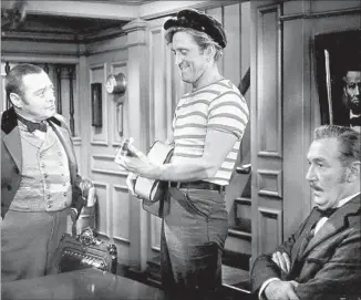  ?? Walt Disney Production­s ?? “20,000 LEAGUES UNDER THE SEA” (1954) with Peter Lorre, left, and Paul Lukas: Douglas delivers a jaunty turn as a harpooner aboard a frigate that heads off to study mysterious activity.