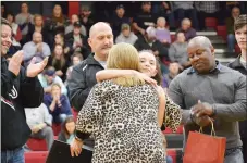  ?? TIMES file photograph ?? Pea Ridge High School sophomore Kennedy Allison hugged school nurse LaRay Thetford Friday, Jan. 18, as her father Keith Allison (left), deputy fire chief Jack Wassman (center), paramedic LaRon Edwards (right), and first responder Riley Heasley (far right) looked on during a special ceremony between the girls and boys basketball games in Blackhawk Gym.