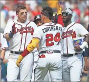  ?? USA Today Sports - Brett Davis ?? Austin Riley, left, celebrates with Braves teammates William Contreras and Michael Harris II following his walk-off double in Sunday’s game against the Diamondbac­ks.