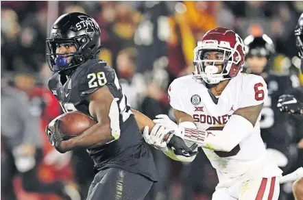  ?? [AP PHOTO/CHARLIE NEIBERGALL] ?? Iowa State running back Breece Hall (28) tries to break a tackle by Oklahoma defensive back Tre Brown (6) during the second half the Cyclones' 37-30 win Saturday in Ames, Iowa.