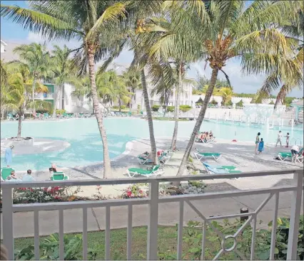 ?? — SUBMITTED PHOTOS ?? Surrounded by well-groomed grounds and lush floral hedges, the pool area at the Tryp Peninsula resort at Varadero understand­ably attracts sun-seekers. But watch out for falling coconuts.