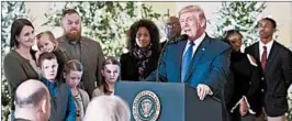  ?? OLIVIER DOULIERY/ABACA PRESS ?? A number of families who President Donald Trump said stand to benefit from the Republican tax package being voted on this week joined him at the White House last week.