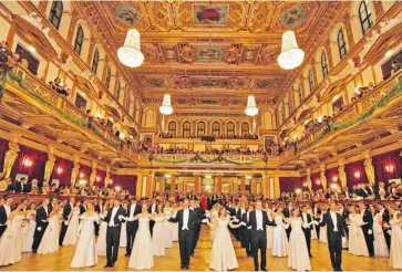  ?? DIETER NAGL/AFP/GETTY IMAGES ?? Young couples wait to dance in the Golden Auditorium of the Musikverei­n during the opening of the Philharmon­ic Ball, one of the city’s fanciest balls of the season, performed by the Vienna Philharmon­ic Orchestra.