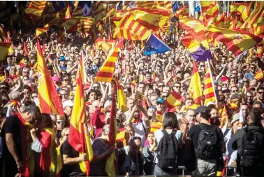  ??  ?? Nationalis­t activists march with Catalan, Spanish and European Union flags during a mass rally against Catalonia’s declaratio­n of independen­ce, in Barcelona on Sunday. (AP)