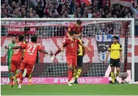  ?? AFP ?? Bayern’s players celebrate a goal against Dortmund. —