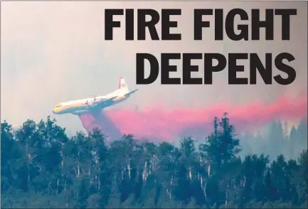  ?? The Canadian Press ?? A tanker drops retardant while battling the Shovel Lake wildfire near Fraser Lake, B.C., on Friday.