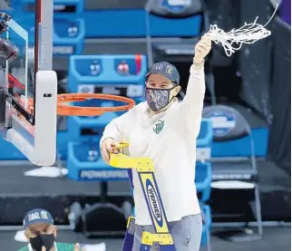  ?? ANDY LYONS/GETTY ?? Coach Scott Drew of the Baylor Bears cuts the net and celebrates after defeating the Arkansas Razorbacks in the Elite Eight round of the 2021 NCAA Men’s Basketball Tournament at Lucas Oil Stadium on March 29, 2021 in Indianapol­is.