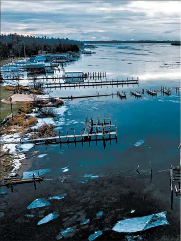  ??  ?? A dock of a boathouse at Snows Channel at Les Cheneaux Islands has been dismantled or washed away.