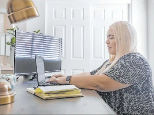  ?? Elizabeth Page Brumley Las Vegas Review-Journal ?? Cassie Catania-Hsu, who started a new job at CBRE Group’s Las Vegas office in June, works from her home Thursday in Henderson. She has establishe­d a routine, but says, “I cannot wait to go back to the office.”