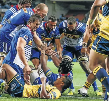  ?? Picture: NIC BOTHMA/EPA ?? BLUE WAVE: Stormers flank Siya Kolisi, centre, is helped up by teammates after scoring a try against the former champions Brumbies during their Super Rugby match at Newlands last night