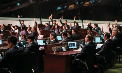  ?? ?? Lawmakers vote during the second reading of the safeguardi­ng national security bill at the legislativ­e council in Hong Kong. Photograph: Joyce Zhou/Reuters