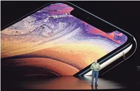  ??  ?? Phil Schiller, Apple’s senior vice president of worldwide marketing, touts the iPhone XS, which starts at $999.