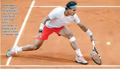  ??  ?? Rafael Nadal returns against Daniel Brands in their first round match of the French Open tennis tournament, at Roland Garros stadium in Paris on Monday. (AP)