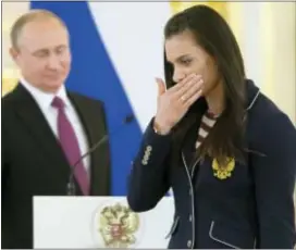  ?? ALEXANDER ZEMLIANICH­ENKO — THE ASSOCIATED PRESS ?? Russia’s pole vaulter and Olympic champion Yelena Isinbayeva gestures after speaking in Moscow on Wednesday during a reception for Russia’s Olympic team. At least 105 athletes from the 387-strong Russian Olympic team announced last week have been...