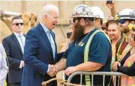  ?? ALEX GALLARDO/AP ?? President Joe Biden shakes hands with Kevin Corbin, a heavy equipment operator, on Thursday in Los Angeles. Biden closed a three-state Western trip Saturday in Oregon.