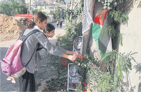  ?? AFP ?? School girls visit the site where veteran Palestinia­n journalist Shireen Abu Akleh was shot dead while covering an Israeli army raid in the occupied West Bank.