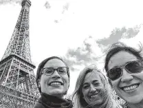  ?? Courtesy photos ?? Ruth Clark, Jennifer Warren and Janice Cruz Cardona, proudly holding their packets at right, did some sightseein­g at the Eiffel Tower after their half-marathon in Paris was canceled.