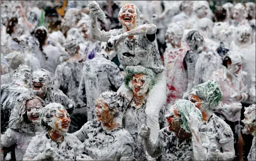  ??  ?? Students take part in a shaving foam fight, known as Raisin Monday, on Lower College lawn at the University of St Andrews in Fife