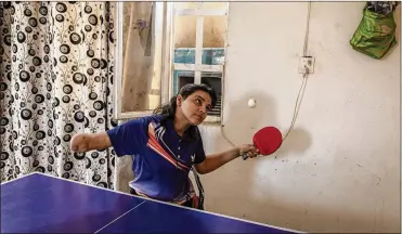  ?? IVOR PRICKETT/THE NEW YORK TIMES ?? Najla Imad Lafta, a triple amputee and member of the Iraqi Paralympic Table Tennis team, trains at her home in Baqubah, Iraq. Najla is one of a growing number of Iraqi athletes competing in sports at a high level after being caught in crossfire or a bombing and losing one or more limbs.