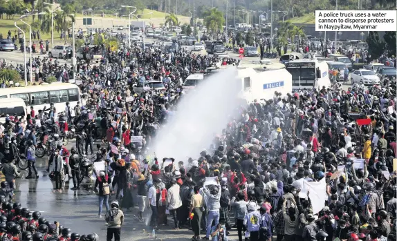  ??  ?? A police truck uses a water cannon to disperse protesters in Naypyitaw, Myanmar