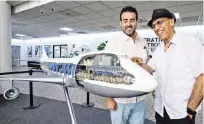  ?? AL DIAZ adiaz@miamiheral­d.com ?? Armando Martinez, right, vice president of flight operations at Miami Air Internatio­nal, checks out a model of a Pan American Airways 747 with Tomas Romero, general manager at World Atlantic Airlines. The model is on display at the former Pan Am Flight Academy building at Miami Internatio­nal Airport.