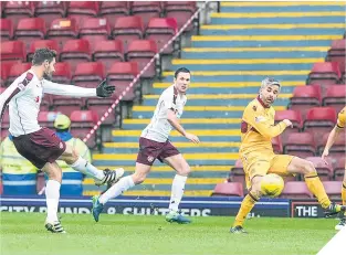  ??  ?? Hearts’ Alexandrio­s Tziolis scores from a deflection off Keith Lasley.