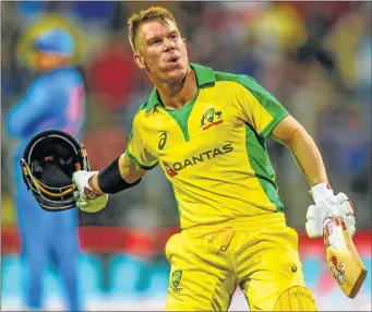  ??  ?? Australia's David Warner celebrates after scoring a century during the first ODI against India at Wankhede Stadium on Thursday