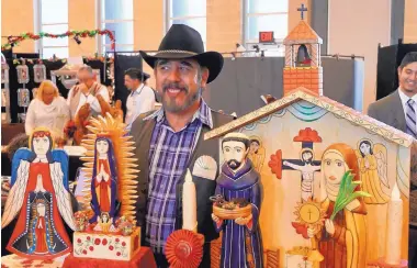  ??  ?? Margarito Mondragon showed his painted bultos, retablos and painted reliefs at the 2017 Winter Spanish Market. This year’s market is Dec. 1-2.