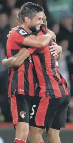  ??  ?? Bournemout­h matchwinne­r Jermain Defoe (left) keeps Brighton’s Shane Duffy at bay, while Andrew Surman hugs Nathan Ake at the end.