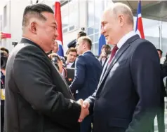  ?? ?? Russian President Vladimir Putin and the Democratic People’s Republic of Korea leader Kim Jong Un greet each other at the Vostochny Cosmodrome outside the city of Uglegorsk, Russia, on Wednesday.