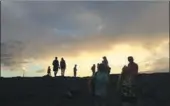  ?? PHOTOS BY CALEB JONES / AP ?? Left: Visitors hike to Kilauea, an active volcano on Hawaii’s Big Island, in Volcanoes National Park. Right: California photograph­er Josh Heidebrech­t takes pictures of lava from Kilauea as it enters the ocean.