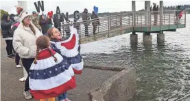  ?? MEEGAN M. REID/USA TODAY NETWORK ?? Kinslee Voigt, 10, yells “Dad!” as she and her sister Mila, 7, watch the USS Nimitz with their mother, Jessica, on Monday.