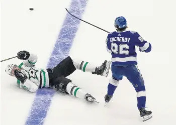  ?? JASON FRANSON/ASSOCIATED PRESS ?? The Tampa Bay Lightning’s Nikita Kucherov, right, checks the Dallas Stars’ Blake Comeau to the ice during Game 2 of the Stanley Cup Final on Monday.