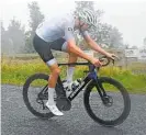  ?? ?? A TA Tour 2022 rider at the top of Maungakawa hill in driving rain.